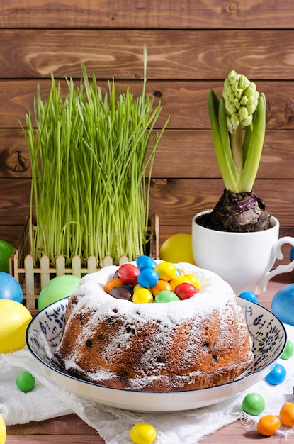 Easter cupcake with powdered sugar and pastry on wooden rustic background