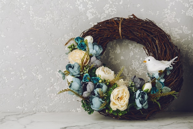 Easter decorated wreath on gray wall