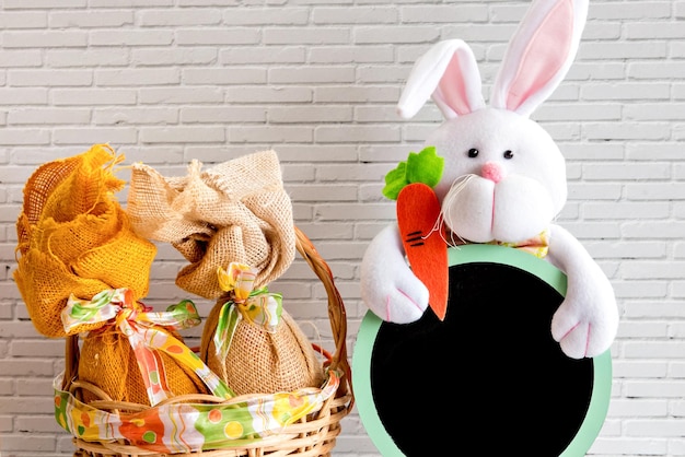 Easter decoration easter egg basket and easter bunny holding chalkboard