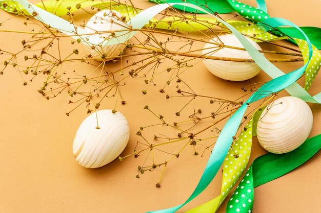 Easter decoration. Eggs, ribbons, fresh flowers and leaves.