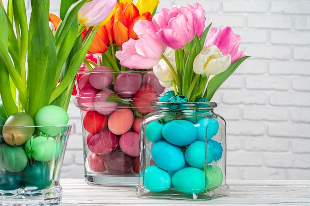 Easter decoration. Flower bouquet with colored eggs