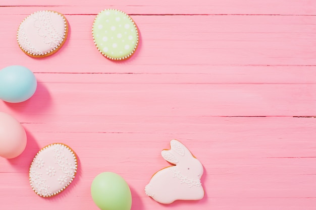 Easter decorations on pink wooden background