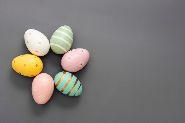 Easter decorative colorful eggs. Grey table, top view, copy space.