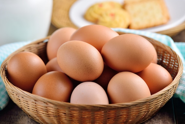 Easter egg in a basket on wodden table