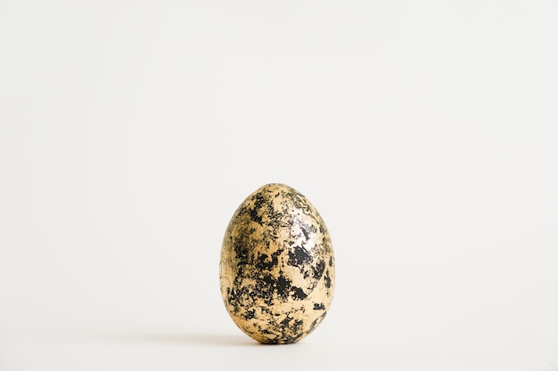 Easter egg decorated with golden potal isolated on white background