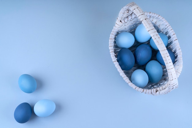 Easter eggs are blue and light blue in a beautiful basket. spring composition