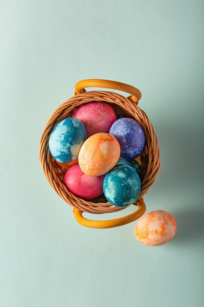 Easter eggs in a basket on a blue background