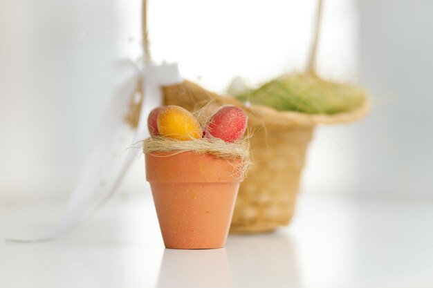 Easter eggs in a basket Chicken eggs twigs with green leaves on the hay Easter holiday concept background Copy space white background