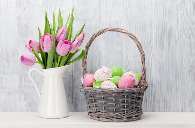 Easter eggs in basket and tulips