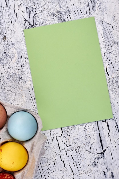 Easter eggs blank greeting card Empty paper on wooden background