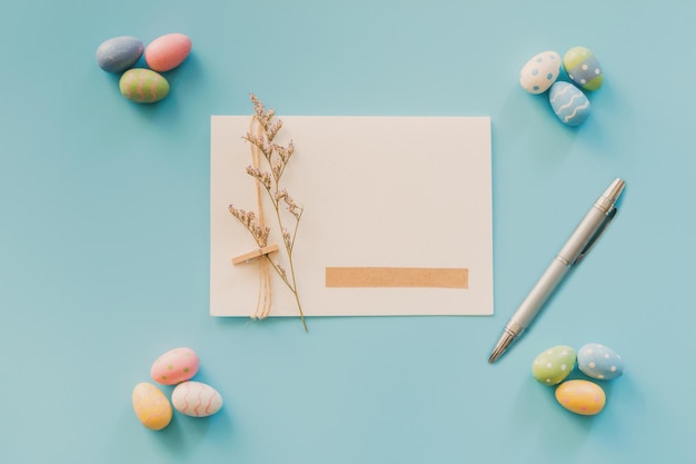 Easter eggs on blue background and greeting card with copy space for text