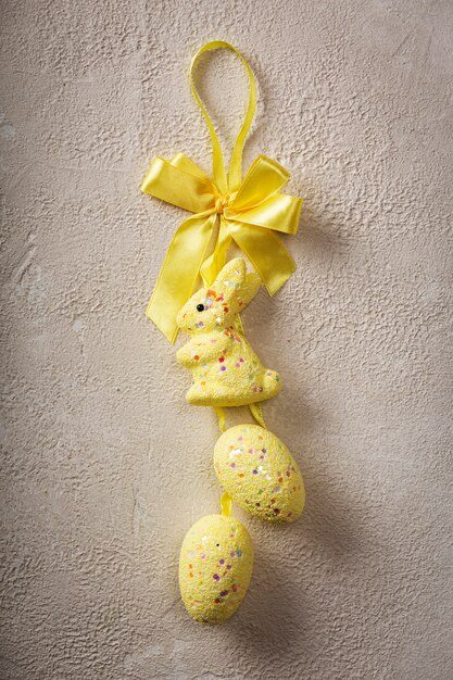 Easter eggs and bunny candies with yellow ribbon