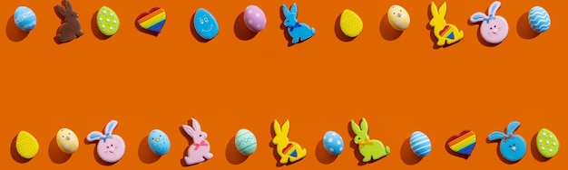 Easter eggs and bunny on an orange table