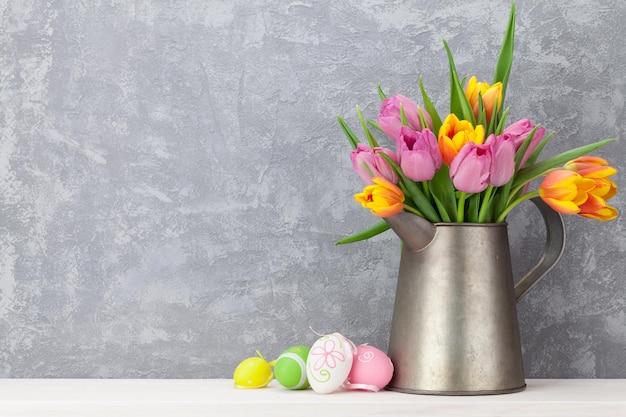 Easter eggs and colorful tulips bouquet