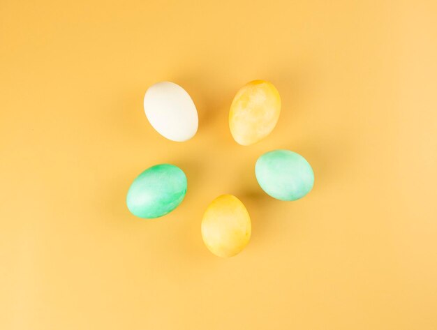 Easter eggs composition in the form of a flower orange background