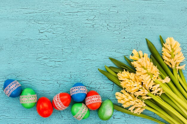 Easter eggs decorated with lace and spring flowers. Copy space, top view