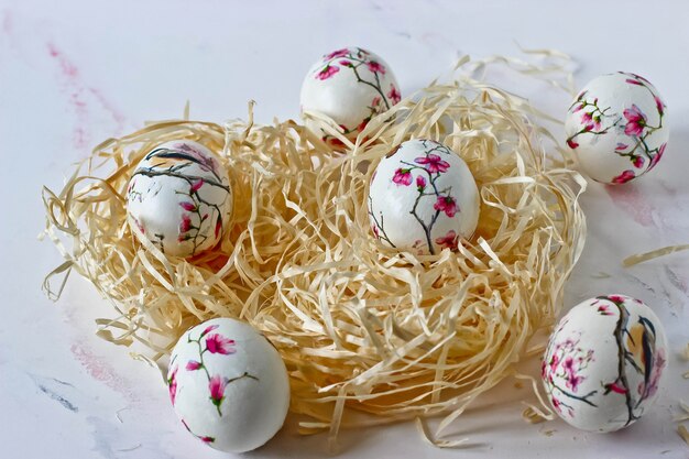 Easter eggs in a decorative nest on a marble background