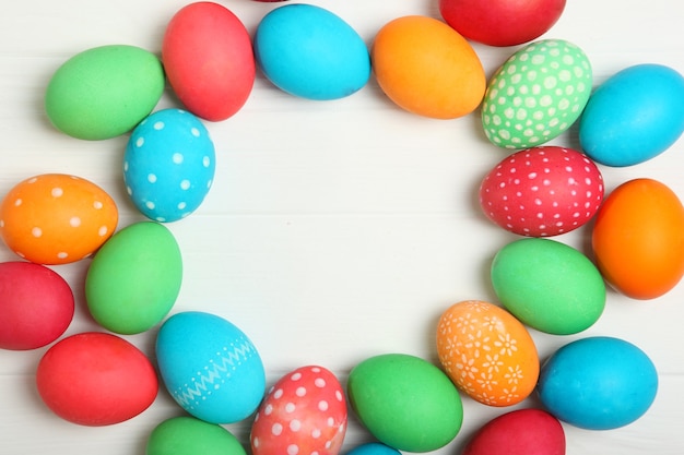 Easter eggs and flowers on the table top view