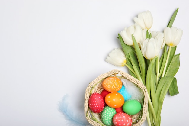 Easter eggs and flowers on the table top view