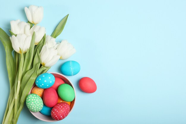 Easter eggs and flowers on the table top view