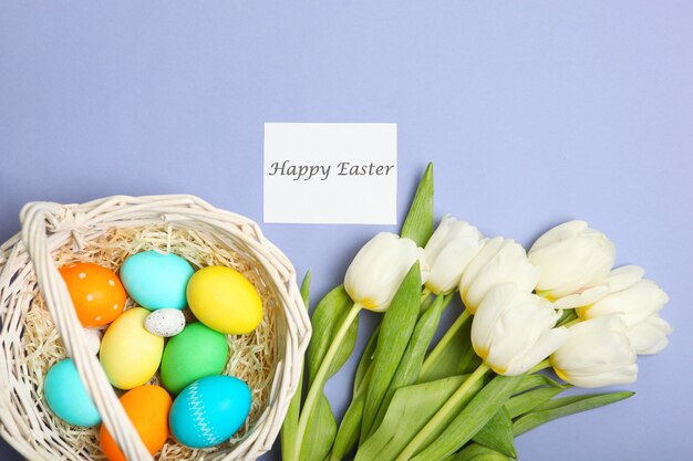 Easter eggs and flowers on the table top view