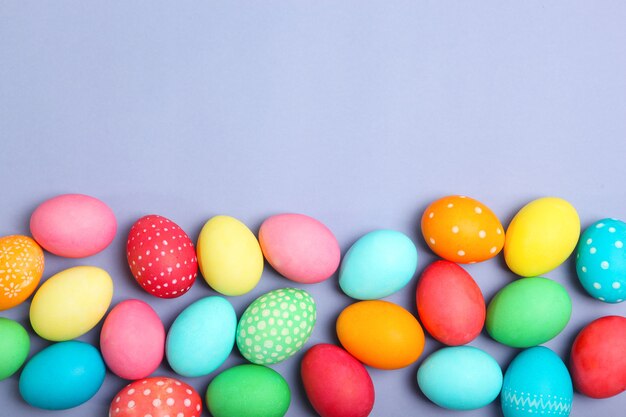 Easter eggs and flowers on the table top view