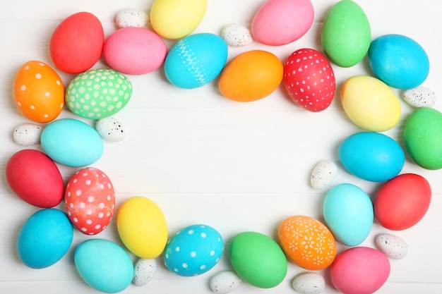 Easter eggs and flowers on the table top view