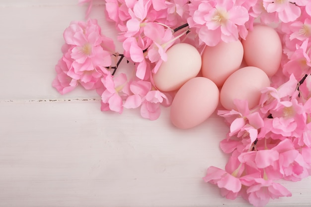 Easter eggs and flowers on white background.