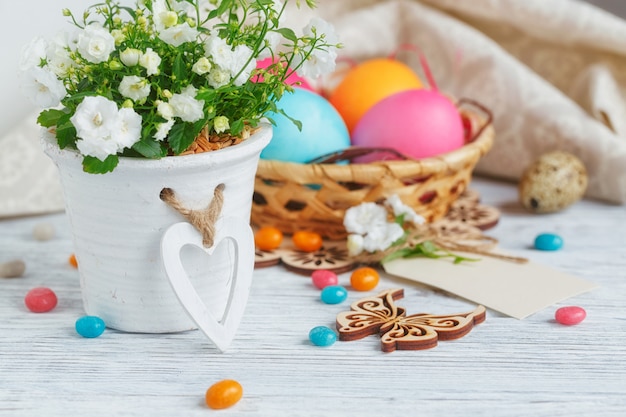 Easter eggs and flowers on a wooden table