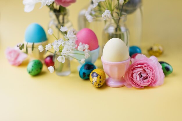 Easter eggs flowers on yellow background