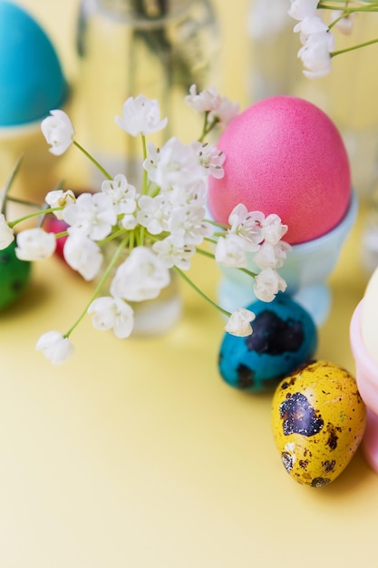 Easter eggs flowers on yellow background