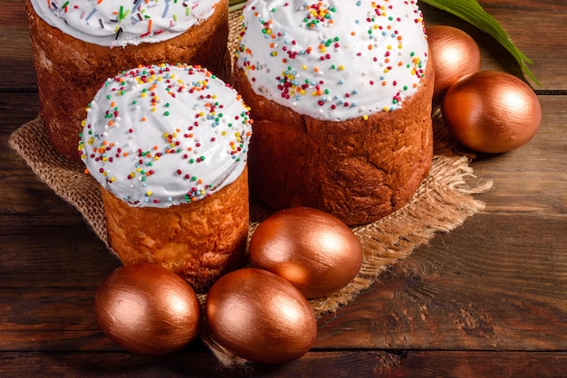 Easter eggs gold and bronze and Easter cake. Preparation for the holiday