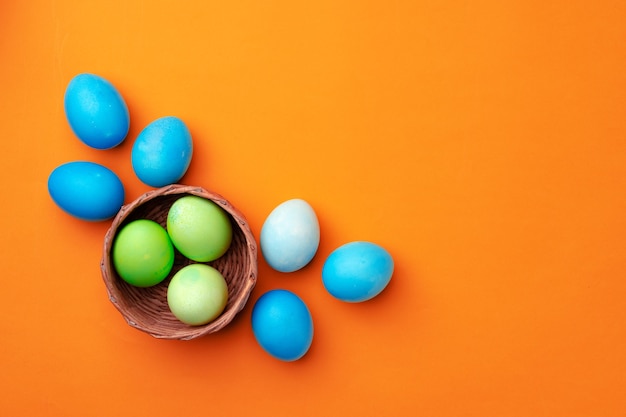 Easter eggs in a nest on orange close up