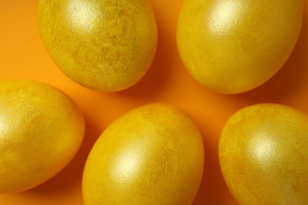 Easter eggs on orange background close up