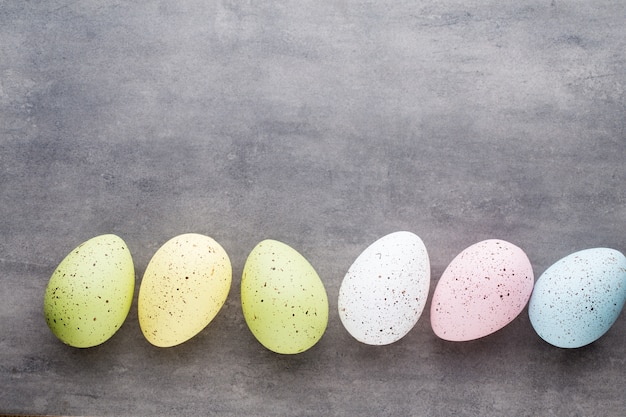 Easter eggs painted in colors on a pattern space.