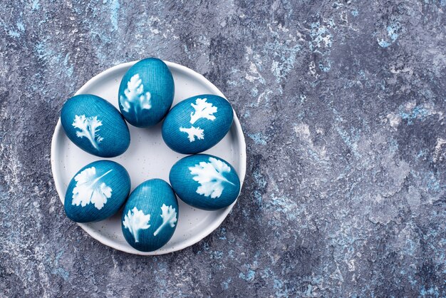 Easter eggs painted of natural dye and decorated with plant leaves