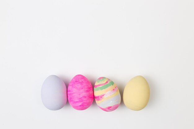 Easter eggs painted in pastel colors on a white background