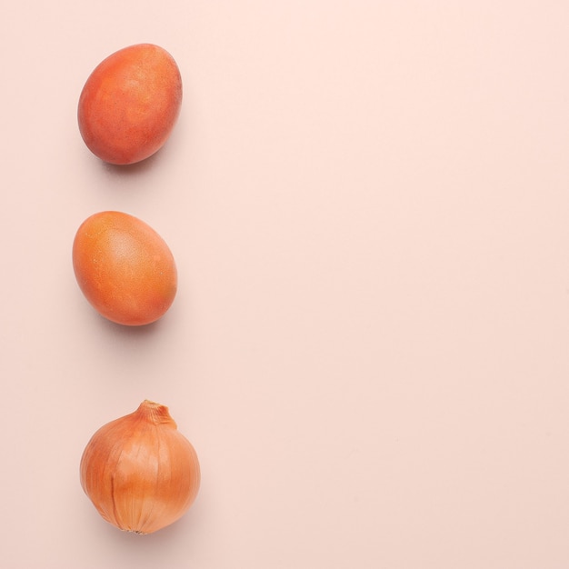 Easter eggs painted with natural dye on a beige background