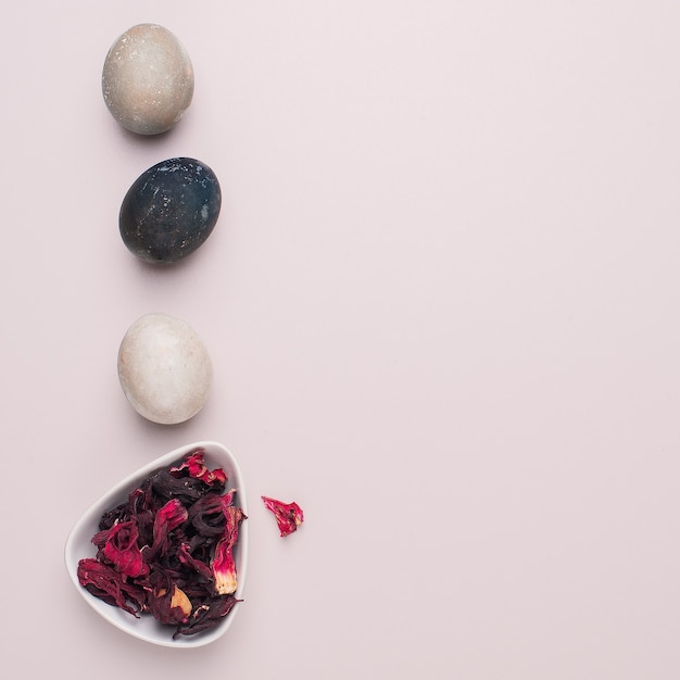 Easter eggs painted with natural dye on a light pink background