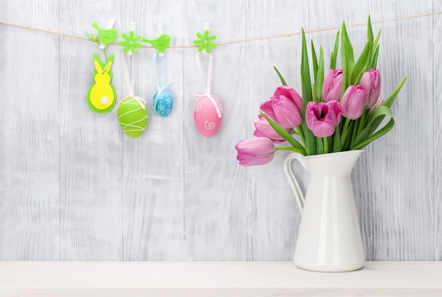 Easter eggs and pink tulips bouquet