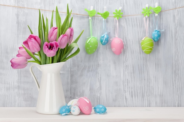 Easter eggs and pink tulips bouquet