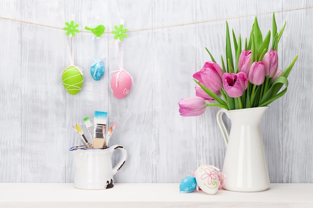 Easter eggs and pink tulips bouquet