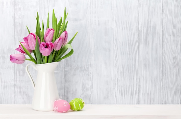 Easter eggs and pink tulips bouquet