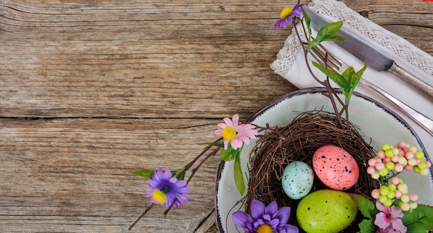 Easter eggs on a plate on wooden background