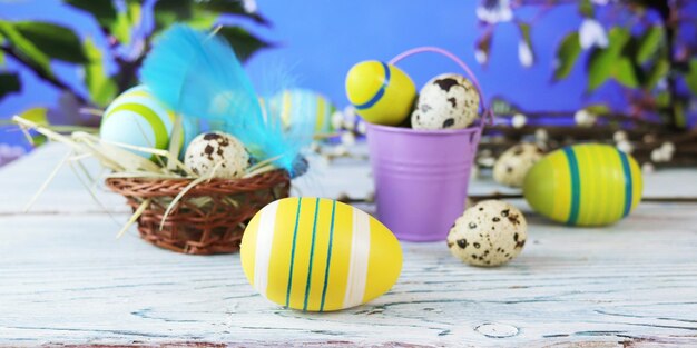 Easter eggs and traditional decorations on a wooden table against the backdrop of spring nature