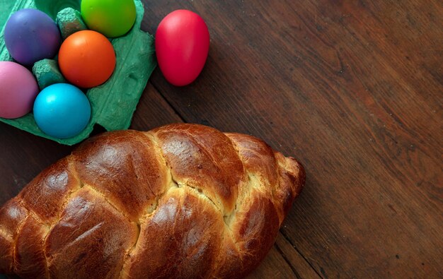 Easter eggs and tsoureki braid greek easter sweet bread on wooden background