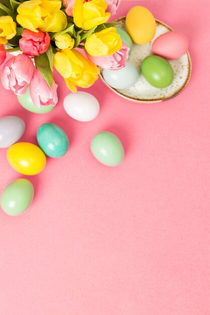 Easter eggs tulip flowers pink background decoration