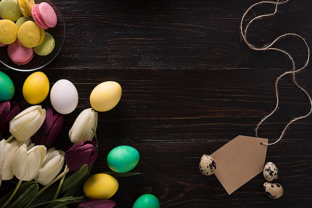 Easter eggs and tulips on a black background