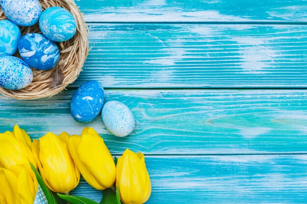 Easter eggs and tulips. festive decoration on wood background