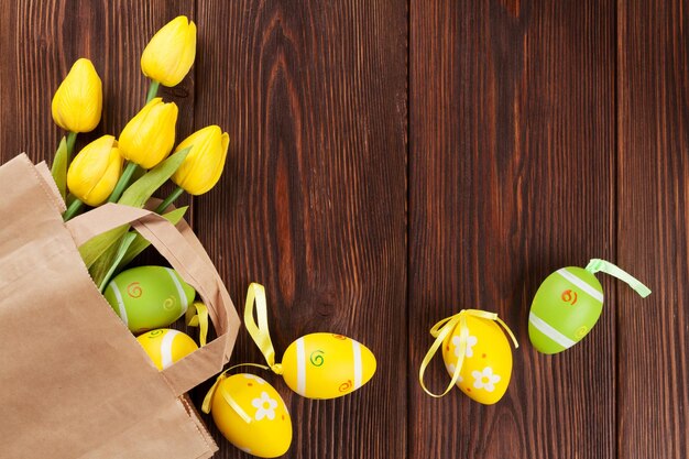 Easter eggs and tulips in paper bag